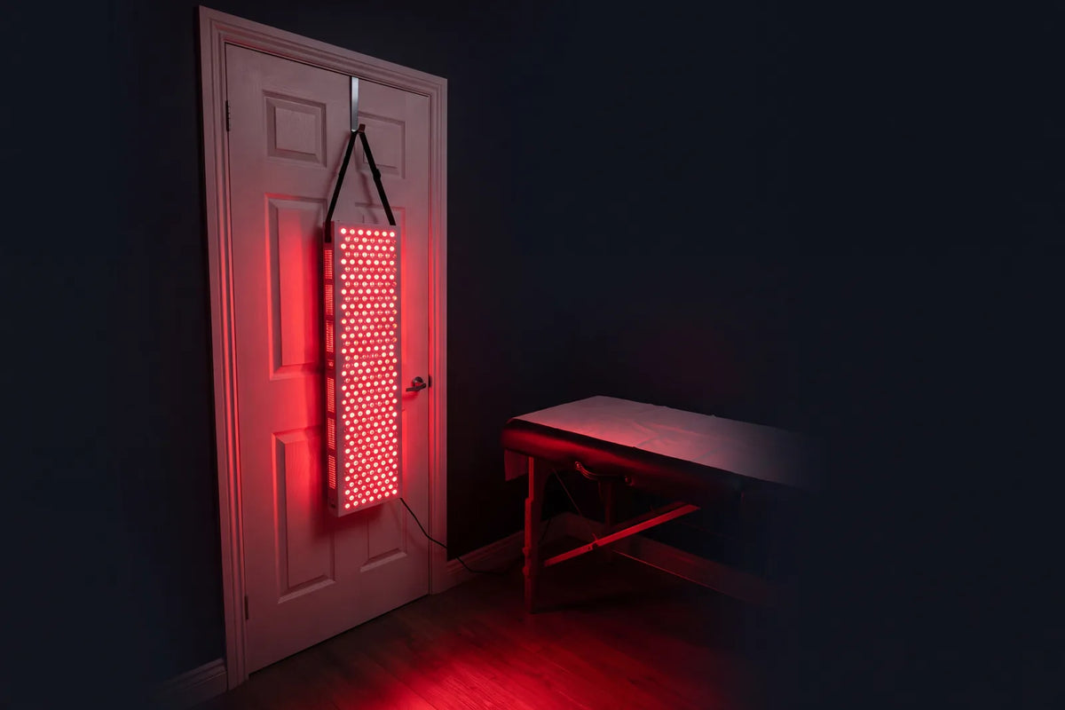 LED 8 encendido, colgado de una puerta junto a una camilla, en una sala a oscuras